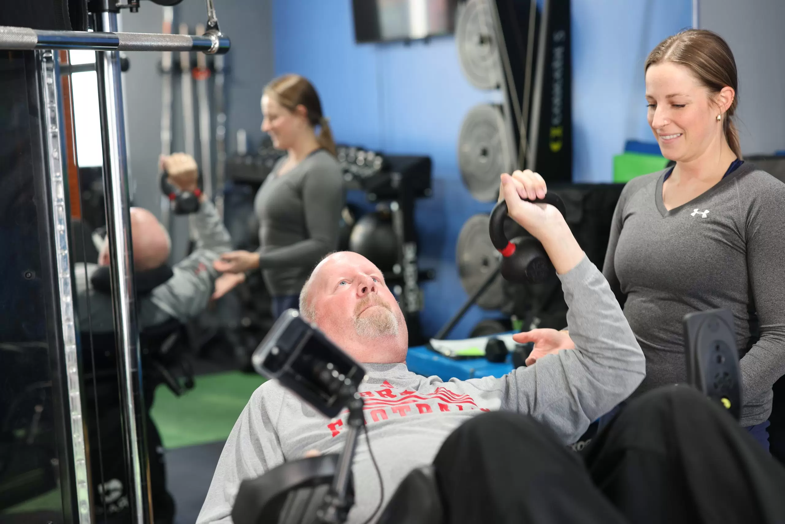 DBNR participant training on an adaptive cable machine