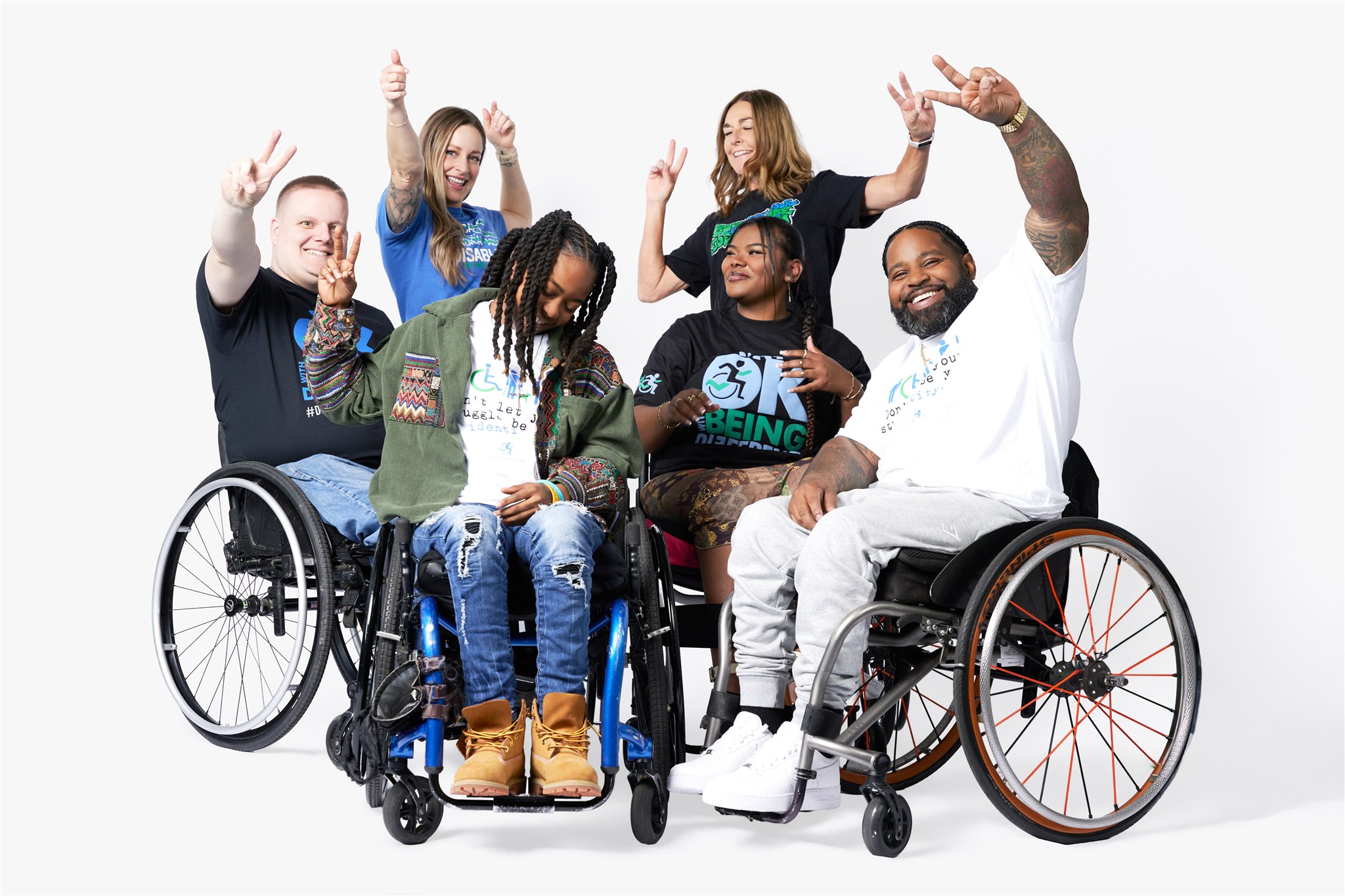 Coach Payton Nowlin flexing alongside two Disabled But Not Really athletes